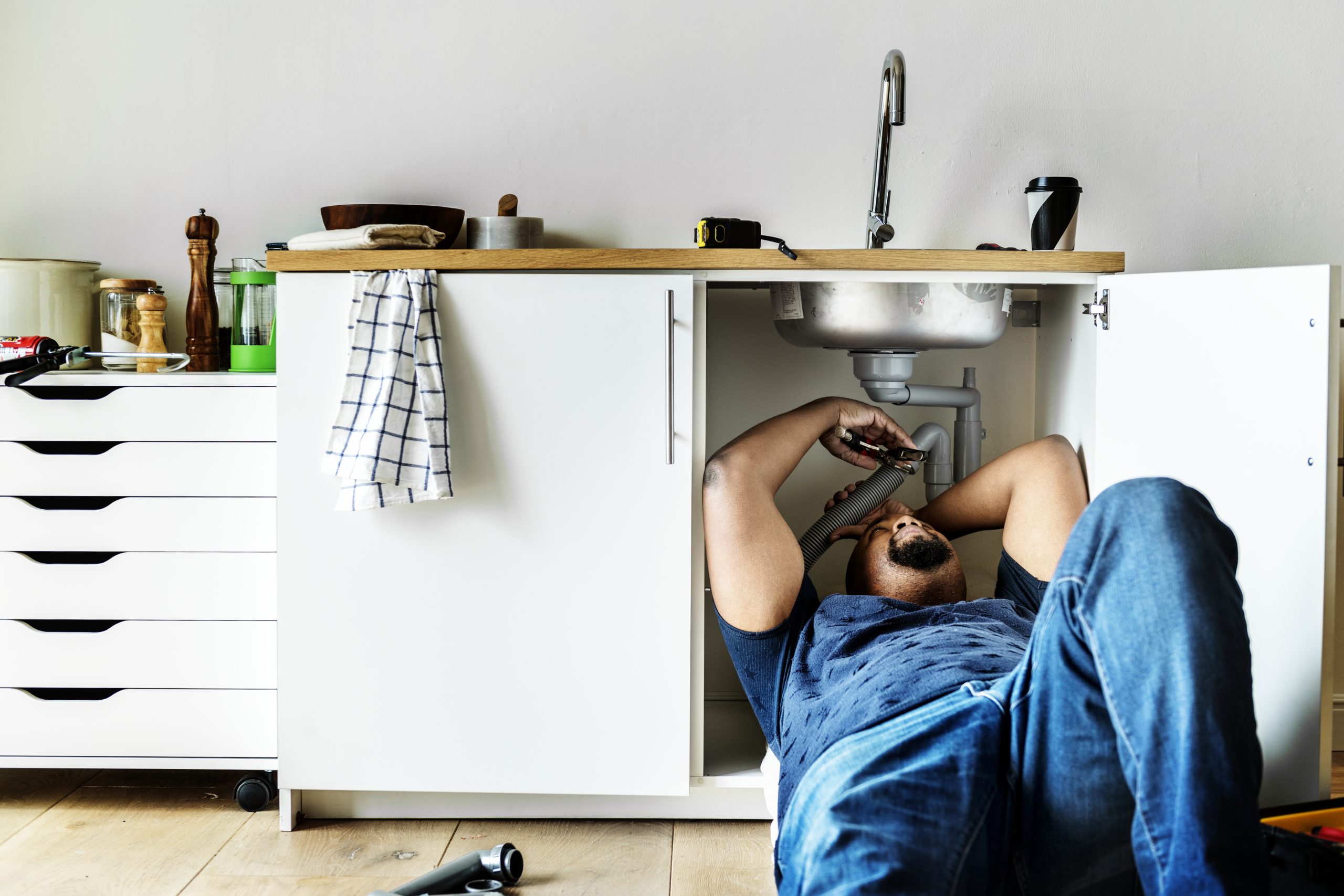 Plumber man fixing kitchen sink